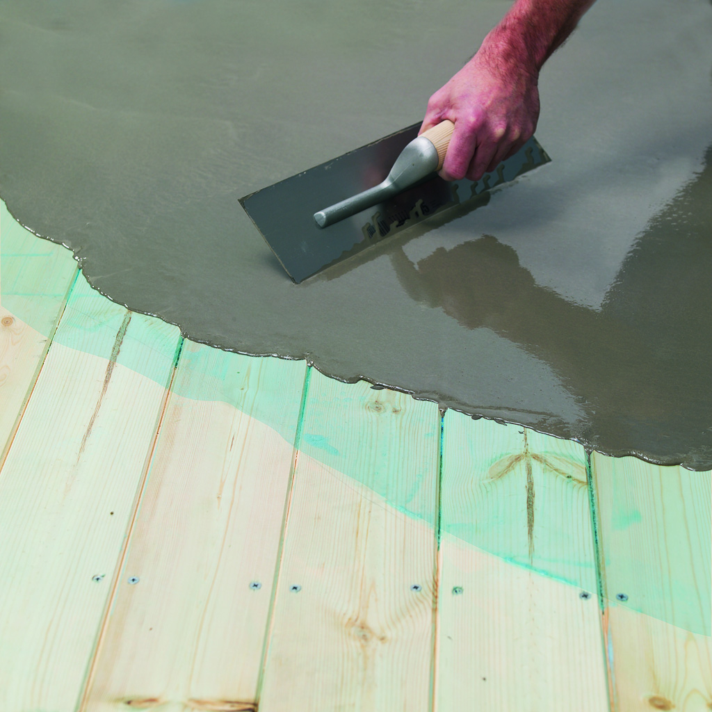 Fibre reinforced smoothing compound applied to wooden floorboards