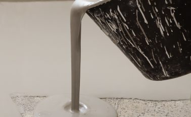 Ardex-A-70-Gypflo-screed-being-poured-from-bucket